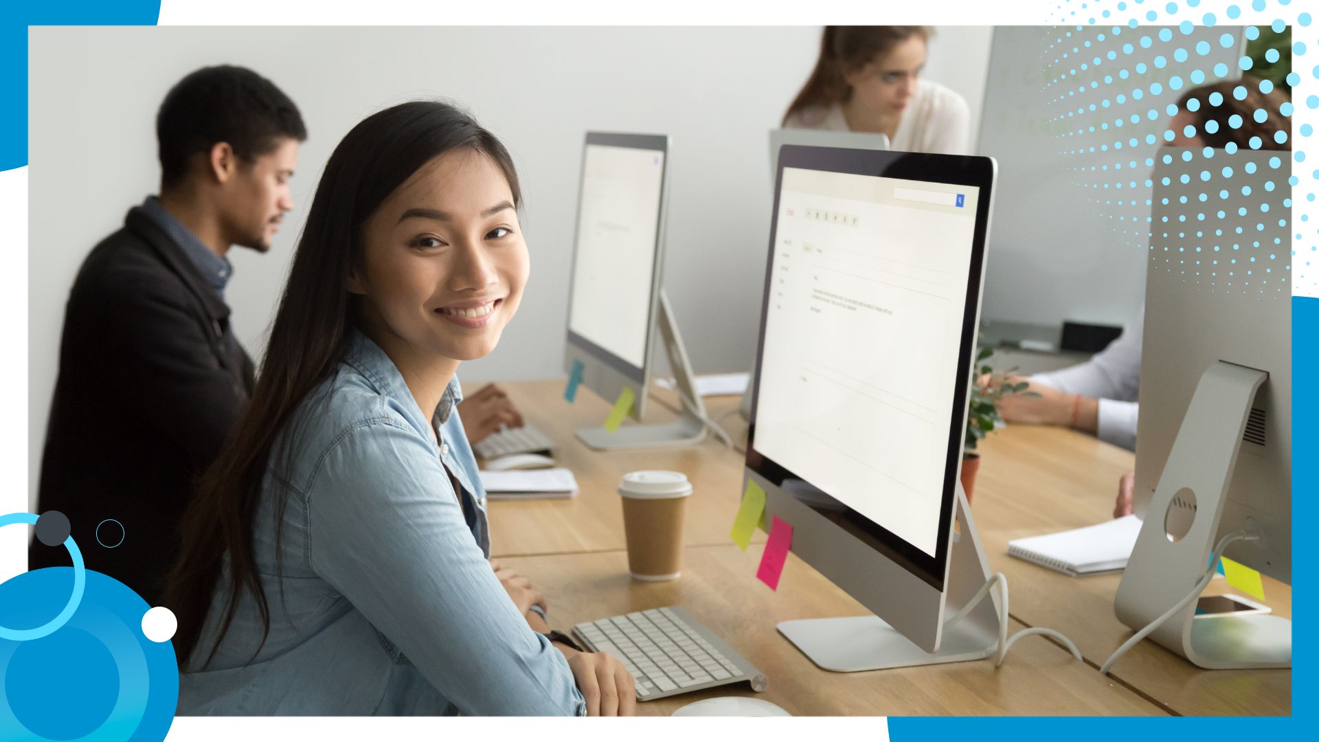 A woman smiling in front of a computer