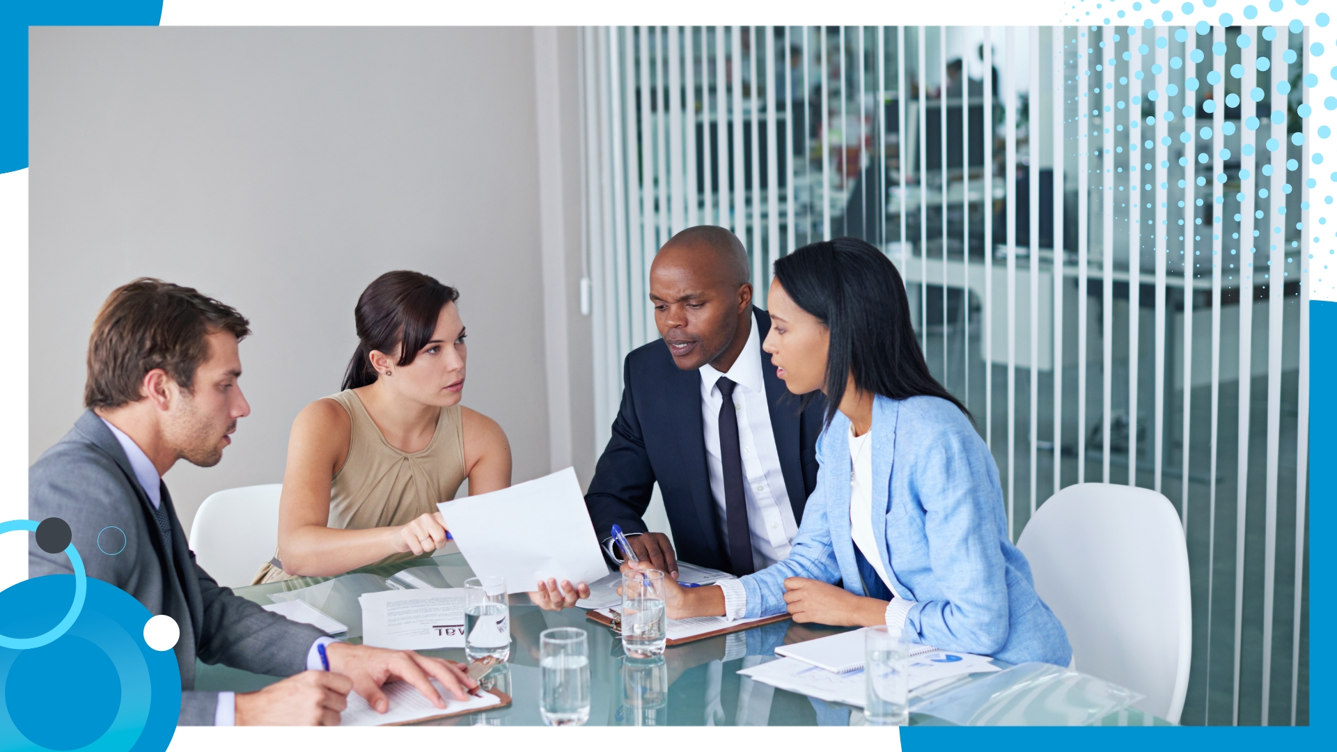 A diverse team of professionals engaged in a meeting, reviewing documents and discussing strategies for effective offshore planning.